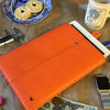 NueVue iPad case orange vegan leather with self cleaning interior lifestyle 1